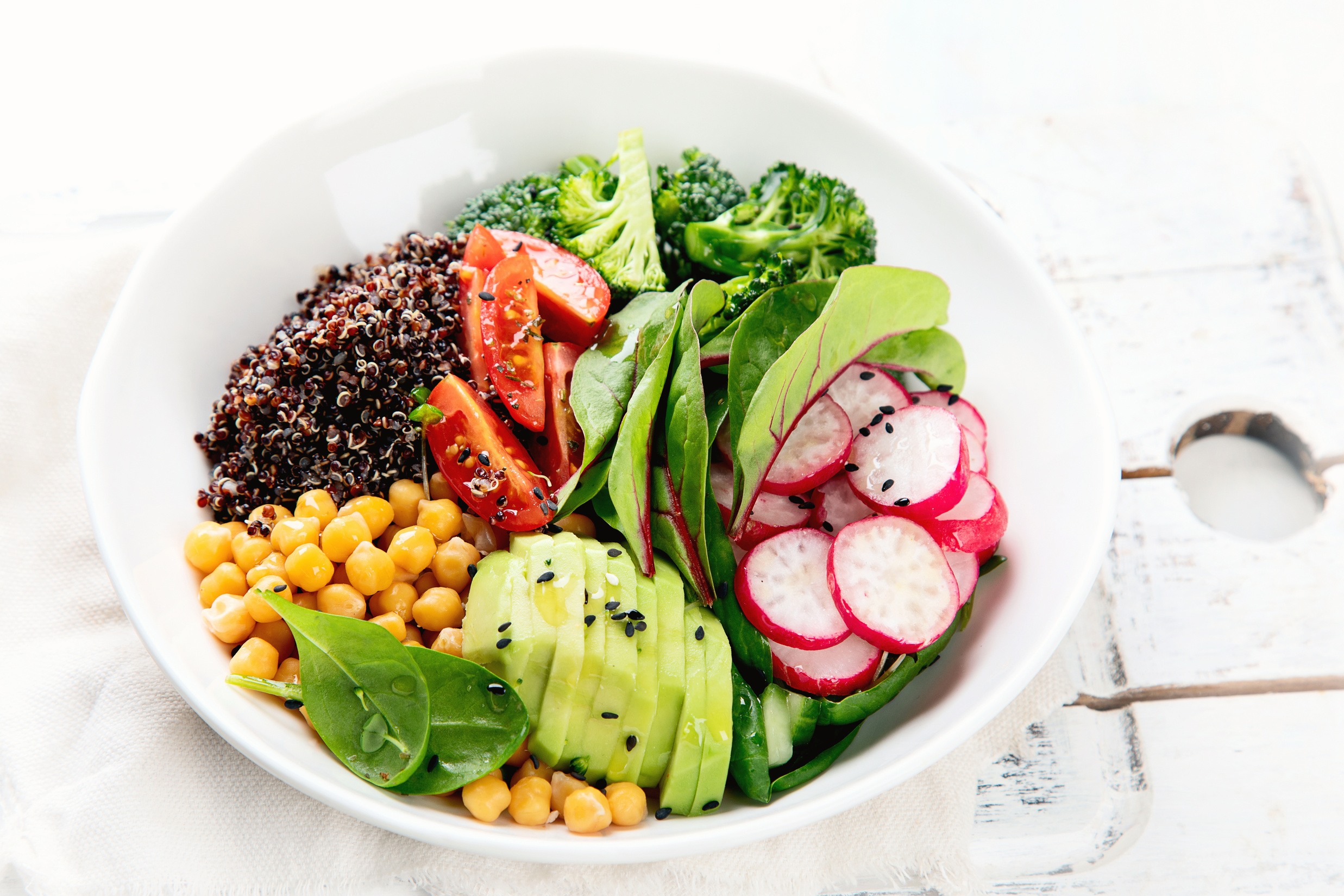 a bowl filled with a variety of vegetables and grains